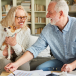 April 25 Events Page Image - Inspirations Elderly man and woman smiling and holding small dog